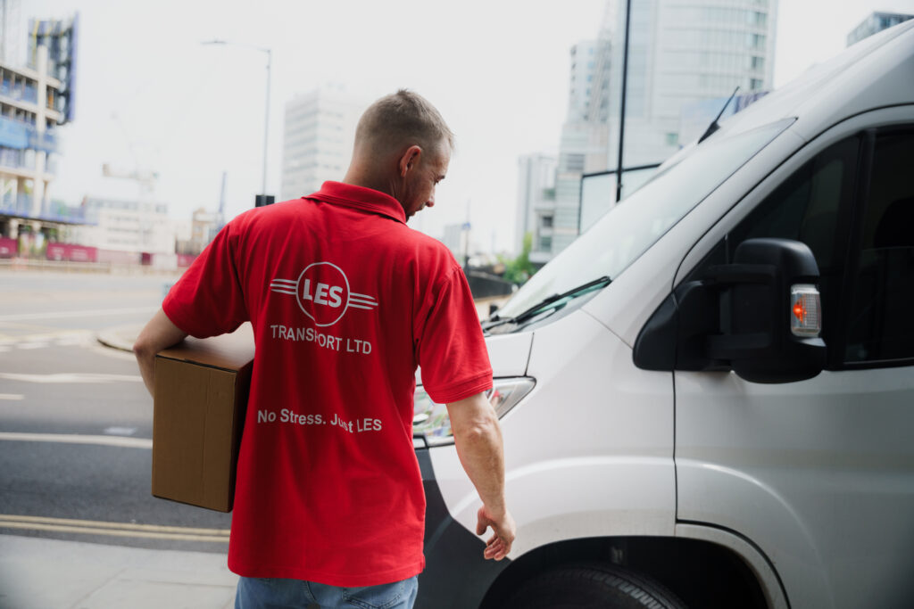 LES Transport driver carrying a parcel to the van